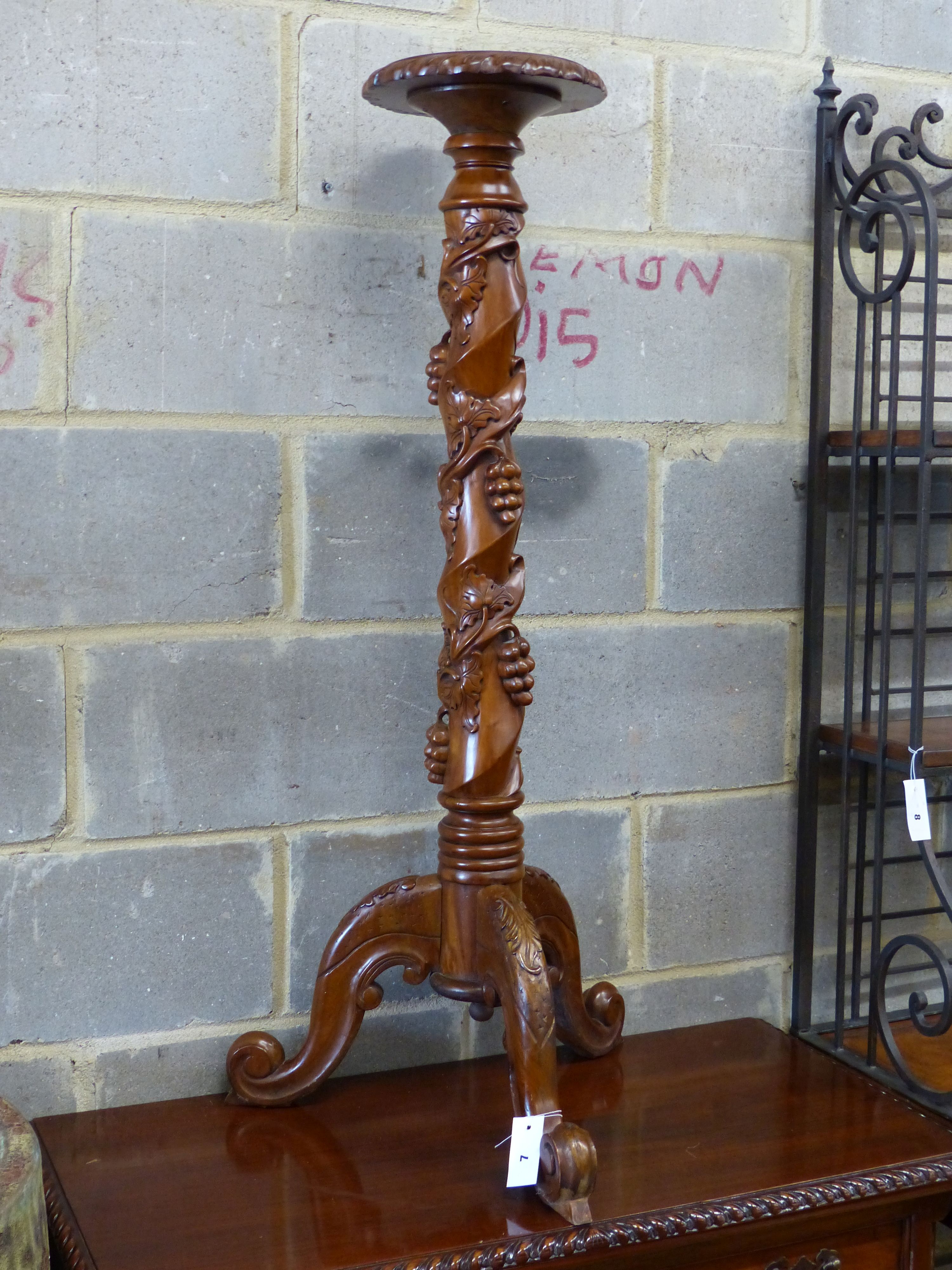 A reproduction carved mahogany torchere, height 114cm